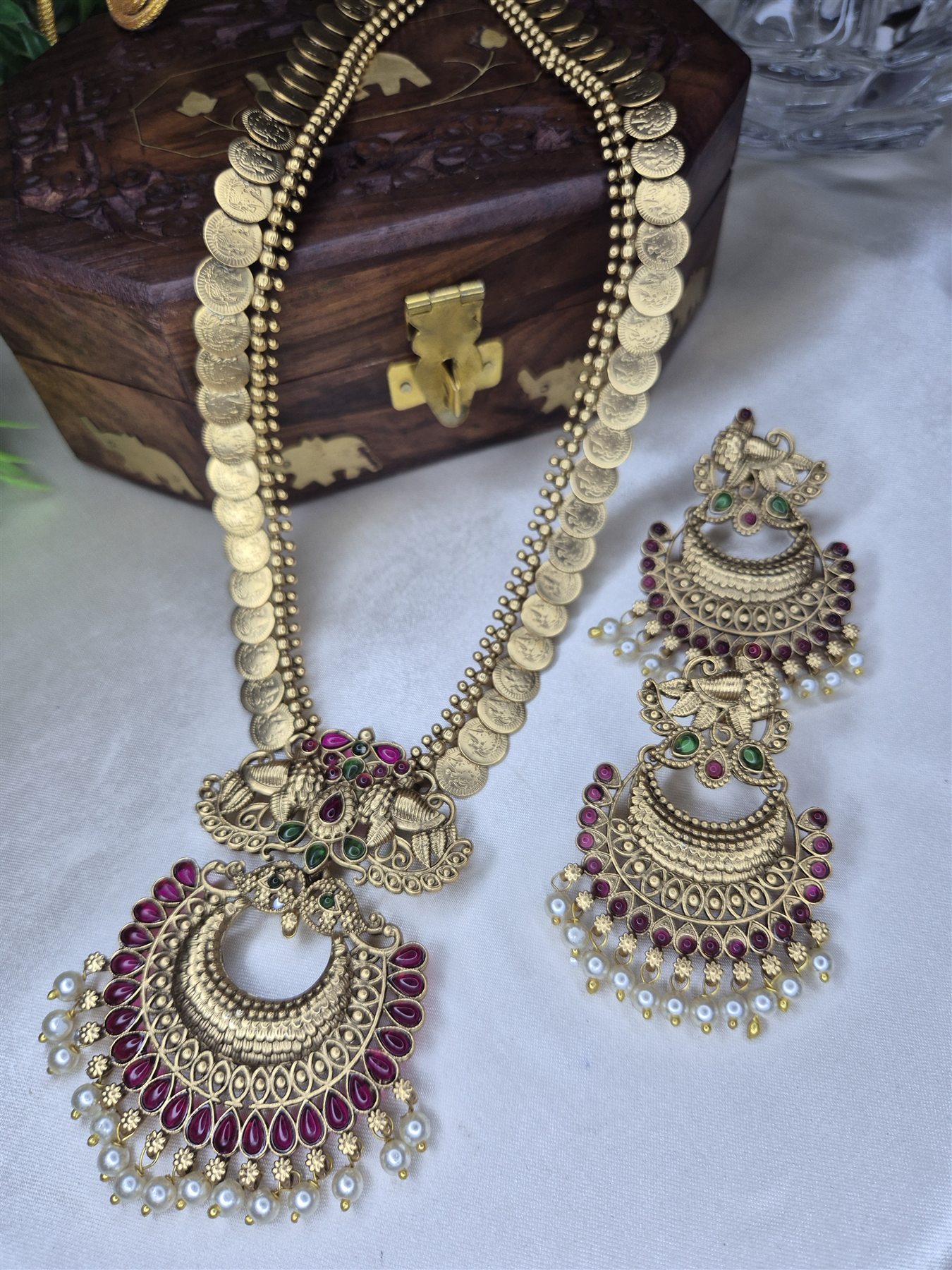 Antique coin necklace with peacock-inspired earrings